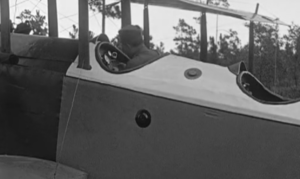 Scene from The Flying Ace (1926): Capt. Billy Stokes in the cockpit of a period airplane